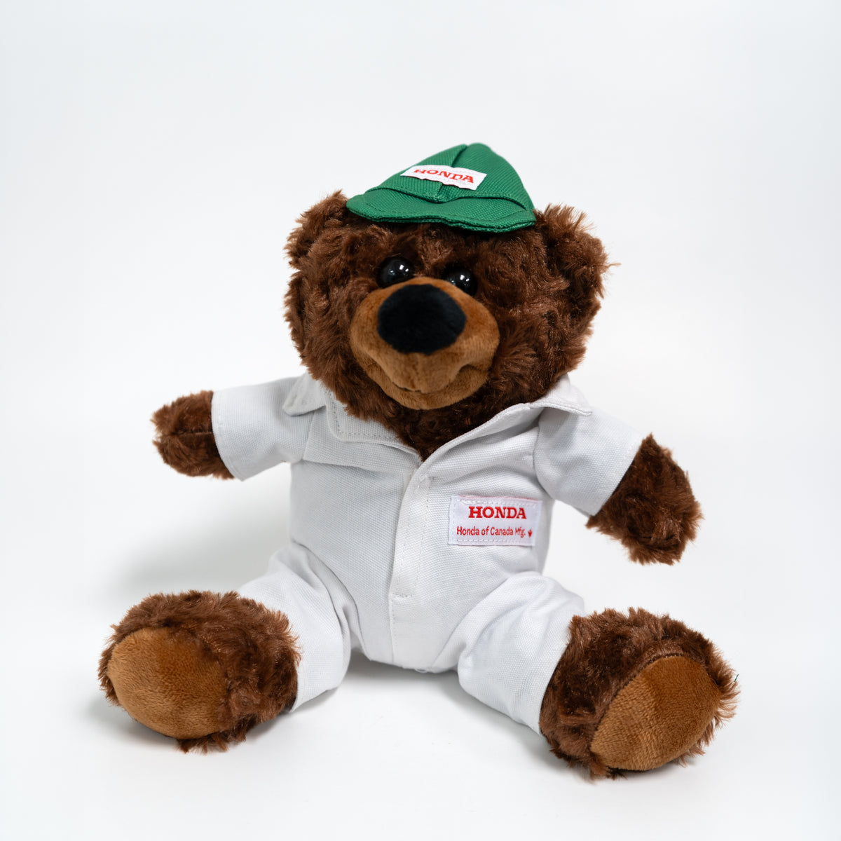 Plush teddy bear in a Honda uniform and cap on a white background