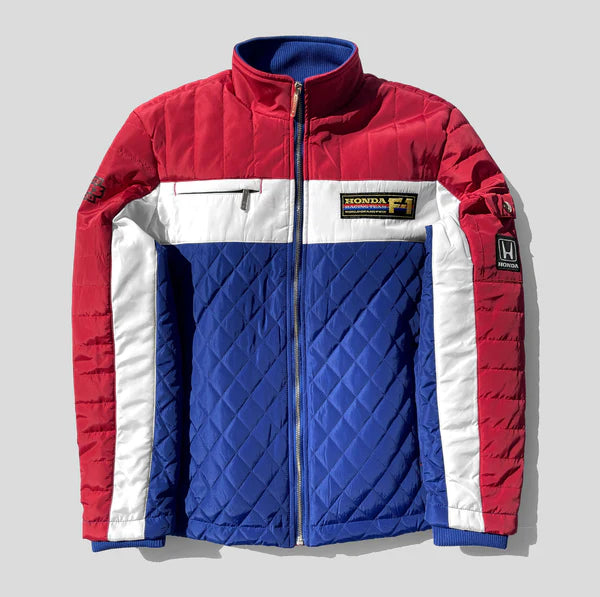 Red, white, and blue quilted jacket with Honda logo on a light gray background