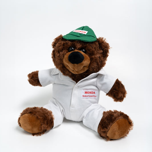 Plush teddy bear in a Honda uniform and cap on a white background