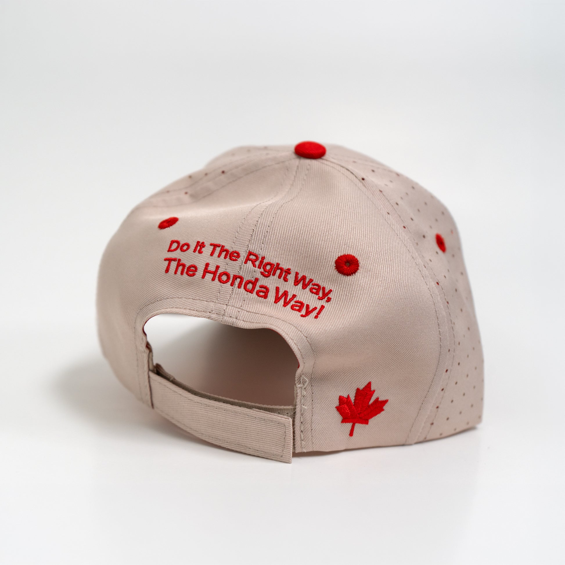 Beige cap with red text and a red maple leaf on a white background