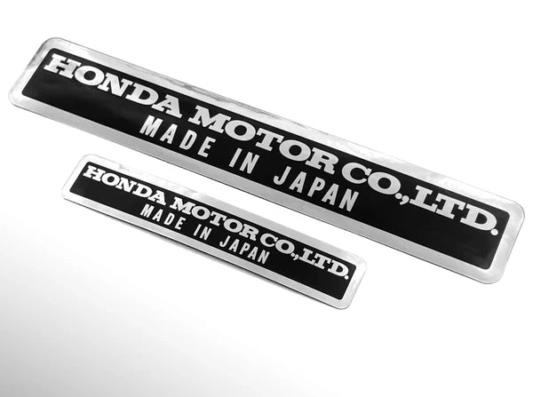 Two Honda Motor Co., Ltd. emblems with 'Made in Japan' text on a white background.